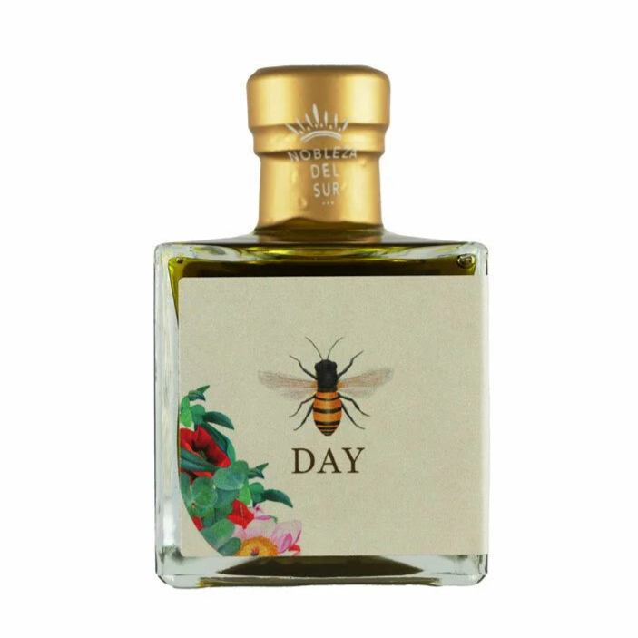 Bottle of olive oil with a gold cap and 'DAY' label on a white background