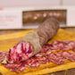 salchichon iberico fermin slices on a wooden board